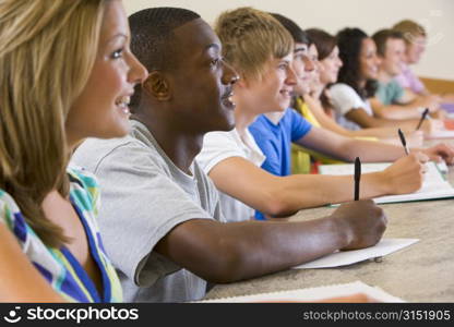 Students in class paying attention and taking notes (selective focus)