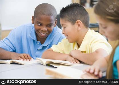 Students in class reading together (selective focus)