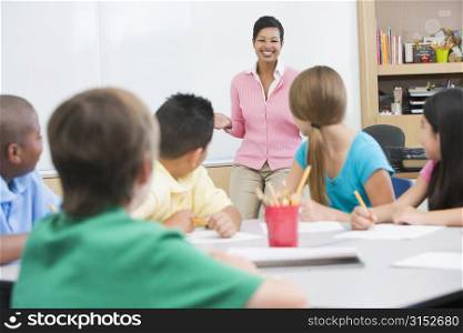 Students in class with teacher lecturing (selective focus)