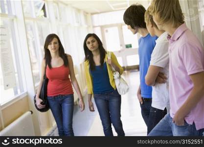 Students in corridor watching other students walking by (selective focus)