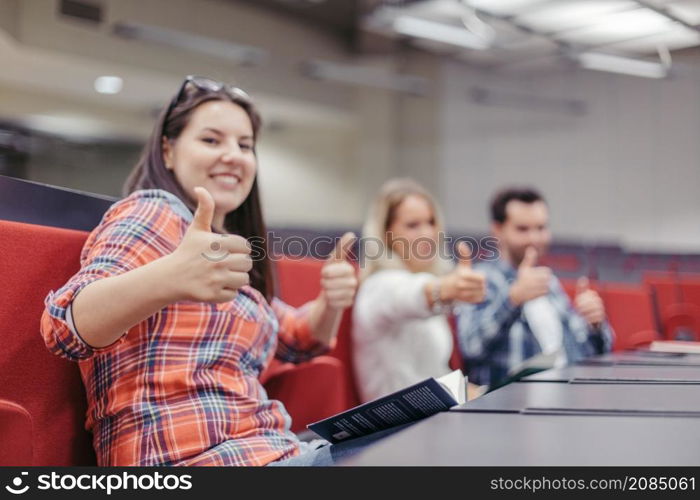 students making thumbs up during break