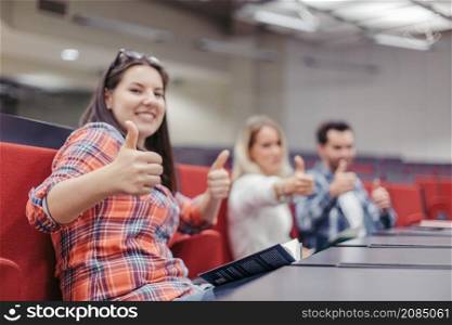 students making thumbs up during break