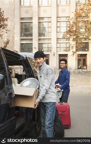 Students moving into dormitory on college campus