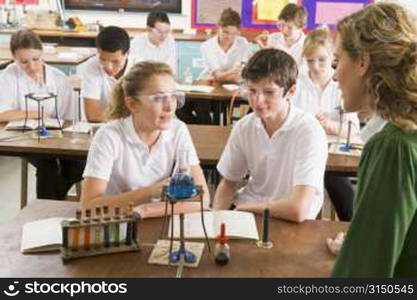 Students performing science experiments in classroom