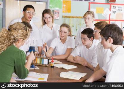 Students receiving chemistry lesson in classroom
