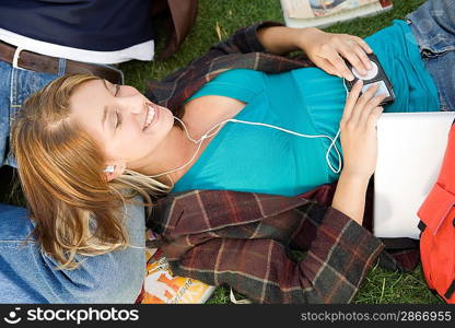 Students relaxing on grass