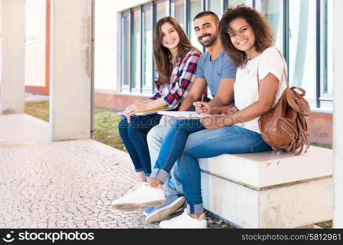 Students sharing notes in the university campus