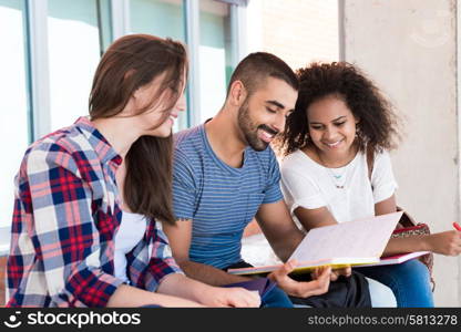 Students sharing notes in the university campus