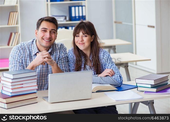 Students sitting and studying in classroom college