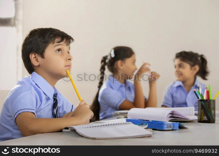 students sitting in their classroom and studying