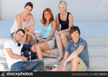 Students sitting on school stairs smiling college friends summer time