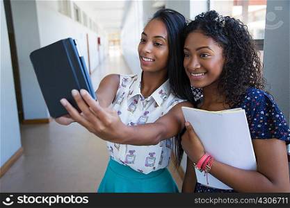 Students standing in hallway, taking selfie