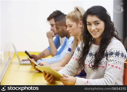 Students Studying In Classroom With Digital Devices