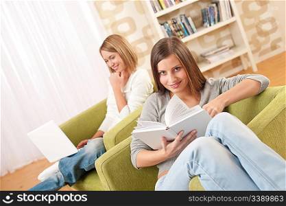 Students - Two female teenager studying in modern living room