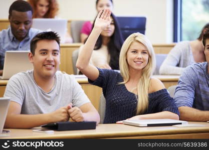 Students Using Laptops And Digital Tablets In Lecture