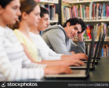 Students Using Laptops in Library