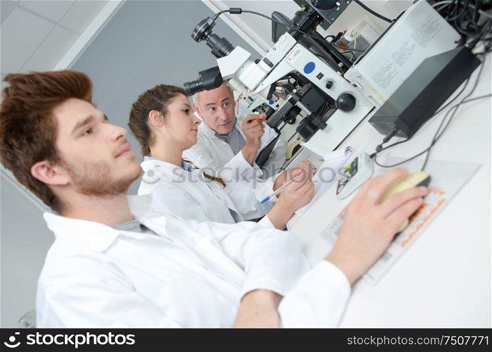 students with their professor in the laboratory