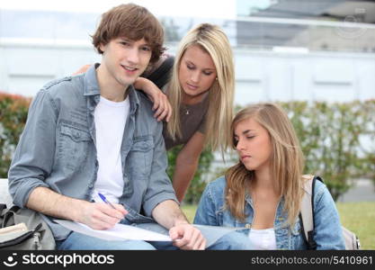 Students working outside college building