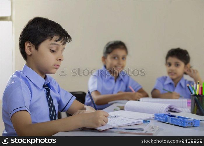 students writing in their notebooks in class
