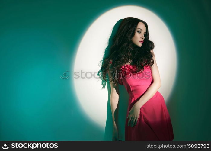 Studio art fashion photo of beautiful sexy yong woman in beam of searchlight. Beautiful brunette woman in beam of searchlight