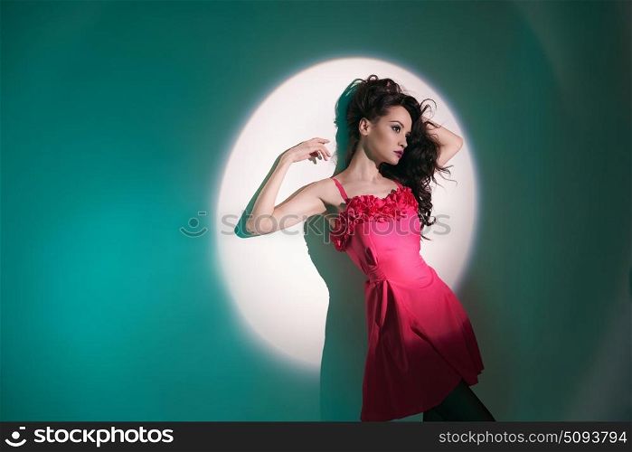 Studio art fashion photo of beautiful sexy yong woman in beam of searchlight. Beautiful brunette woman in beam of searchlight
