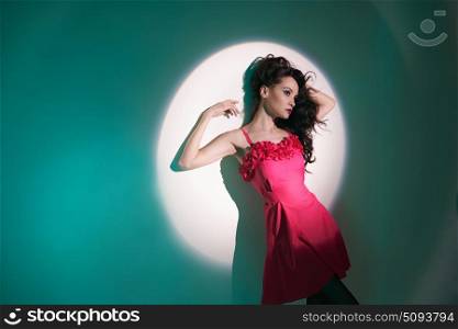 Studio art fashion photo of beautiful sexy yong woman in beam of searchlight. Beautiful brunette woman in beam of searchlight