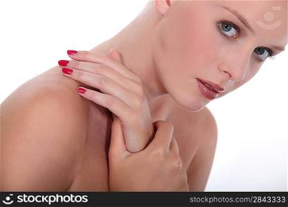 Studio beauty shot of a woman with red painted nails