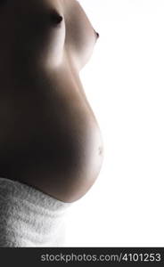 Studio close up of a beautiful pregnant belly on white background