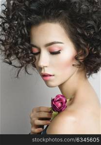 Studio fashion photo of beautiful young woman with violet rose. Valentines day. Spring blossom