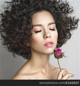 Studio fashion photo of beautiful young woman with violet rose. Valentines day. Spring blossom