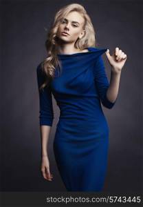Studio fashion photo of elegant beautiful lady in blue dress