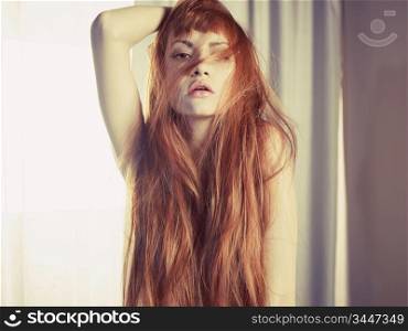 Studio fashion photography of sexy redhead lady