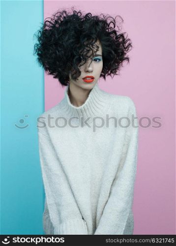 Studio fashion portrait of beautiful asian woman in oversize pullover on colorful pastel background. Stylish look book. Autumn Winter season. Bright spring