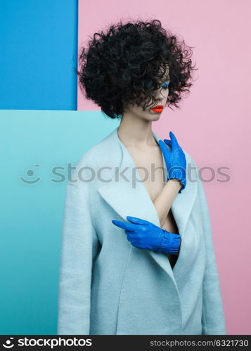 Studio fashion portrait of beautiful asian woman in sky-blue coat on colorful pastel background. Stylish look book. Autumn Winter season. Bright spring