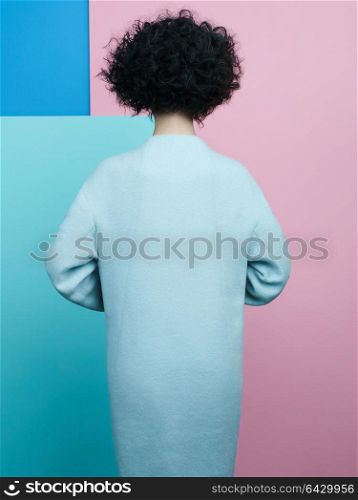 Studio fashion portrait of beautiful asian woman in sky-blue coat on colorful pastel background. Stylish look book. Autumn Winter season. Bright spring