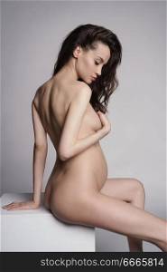 Studio fashion portrait of beautiful pregnant woman. Pretty naked lady.Happy pregnancy. Beauty and health.      