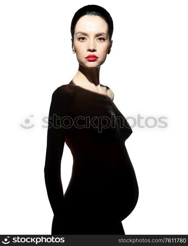 Studio fashion portrait of beautiful pregnant woman. Pretty naked lady.Happy pregnancy. Beauty and health.