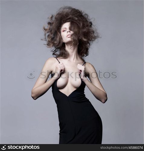 Studio fashion portrait of beautiful sensual woman with volume wavy hair. Big hair