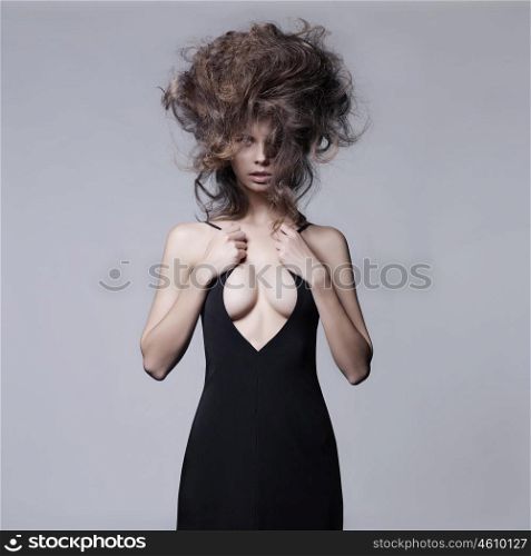 Studio fashion portrait of beautiful sensual woman with volume wavy hair. Big hair