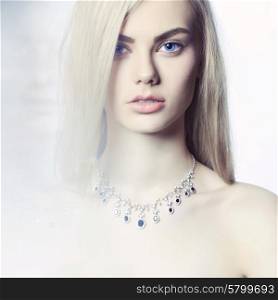 Studio fashion portrait of young beautiful lady in jewelry