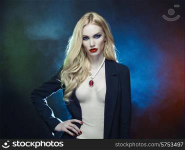 Studio fashion portrait of young beautiful lady on black background
