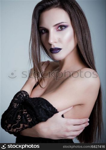 Studio fashion shot: closeup portrait of a pretty young woman. Photo in cold tones