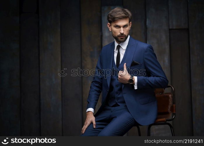 studio indoor photo of young handsome stylish businessman wearing suit. indoor photo of young handsome stylish businessman wearing suit