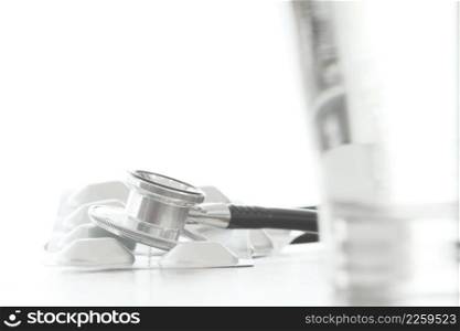 Studio macro of a stethoscope and pills on wood table background copy space