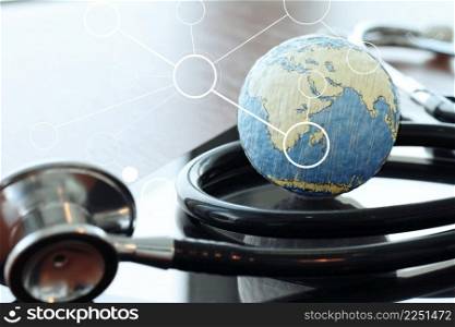 Studio macro of a stethoscope and texture globe with digital tablet with shallow DOF evenly matched abstract as medical network concept Elements of this image furnished by NASA