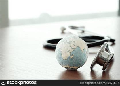 Studio macro of a stethoscope and texture globe with shallow DOF evenly matched abstract as medical network concept Elements of this image furnished by NASA