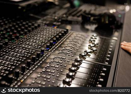 Studio mixing control surface allows controlling the digital audio workstations (DAW). Selective focus.