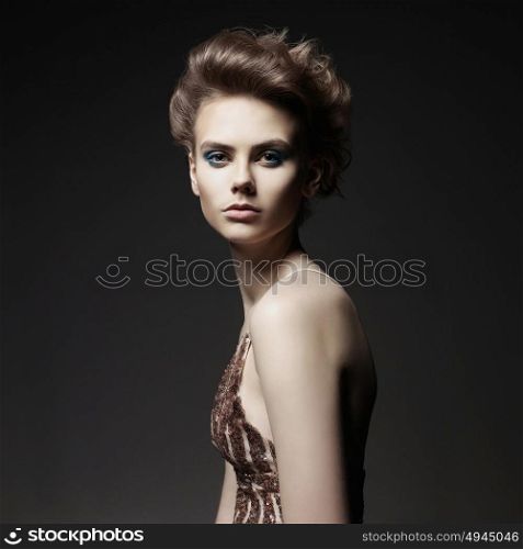 Studio photo of elegant lady with color smoky eyes makeup. Young woman with fashionable haircut