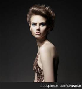 Studio photo of elegant lady with color smoky eyes makeup. Young woman with fashionable haircut