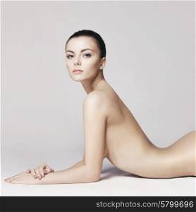 studio photo of elegant naked lady laying on white background